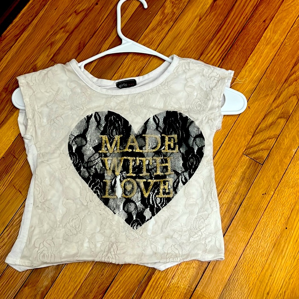 White lace pattern t-shirt with a black heart and gold letters “made with love”